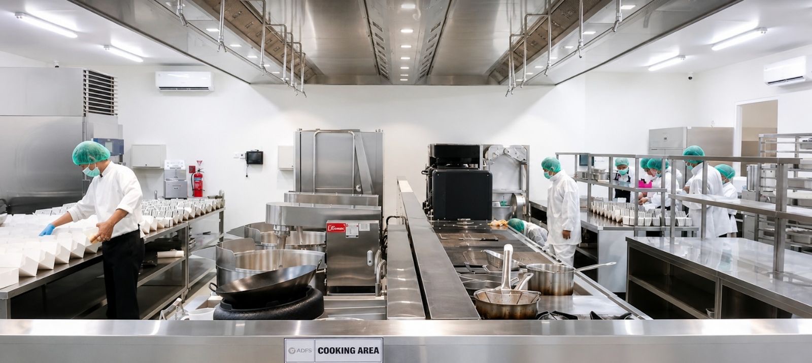 Chefs preparing meals in the ADFoodServices industrial cooking area
