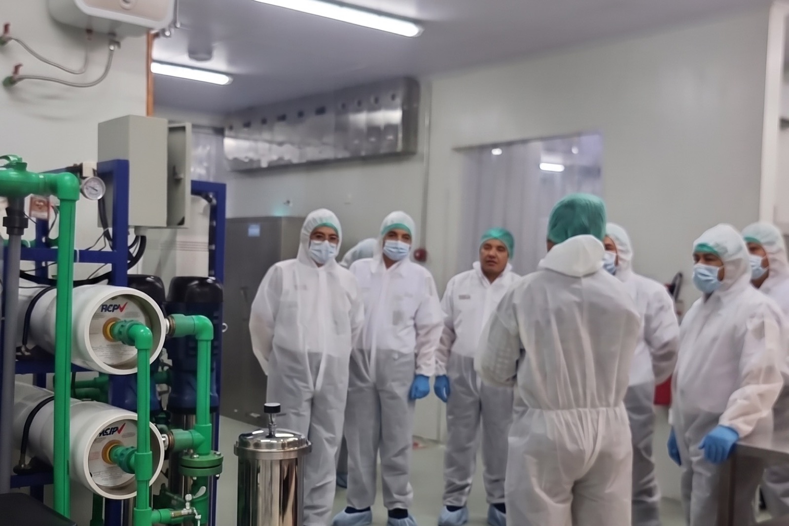 Production staff in full hygiene gear inside the food-safety-controlled facility
