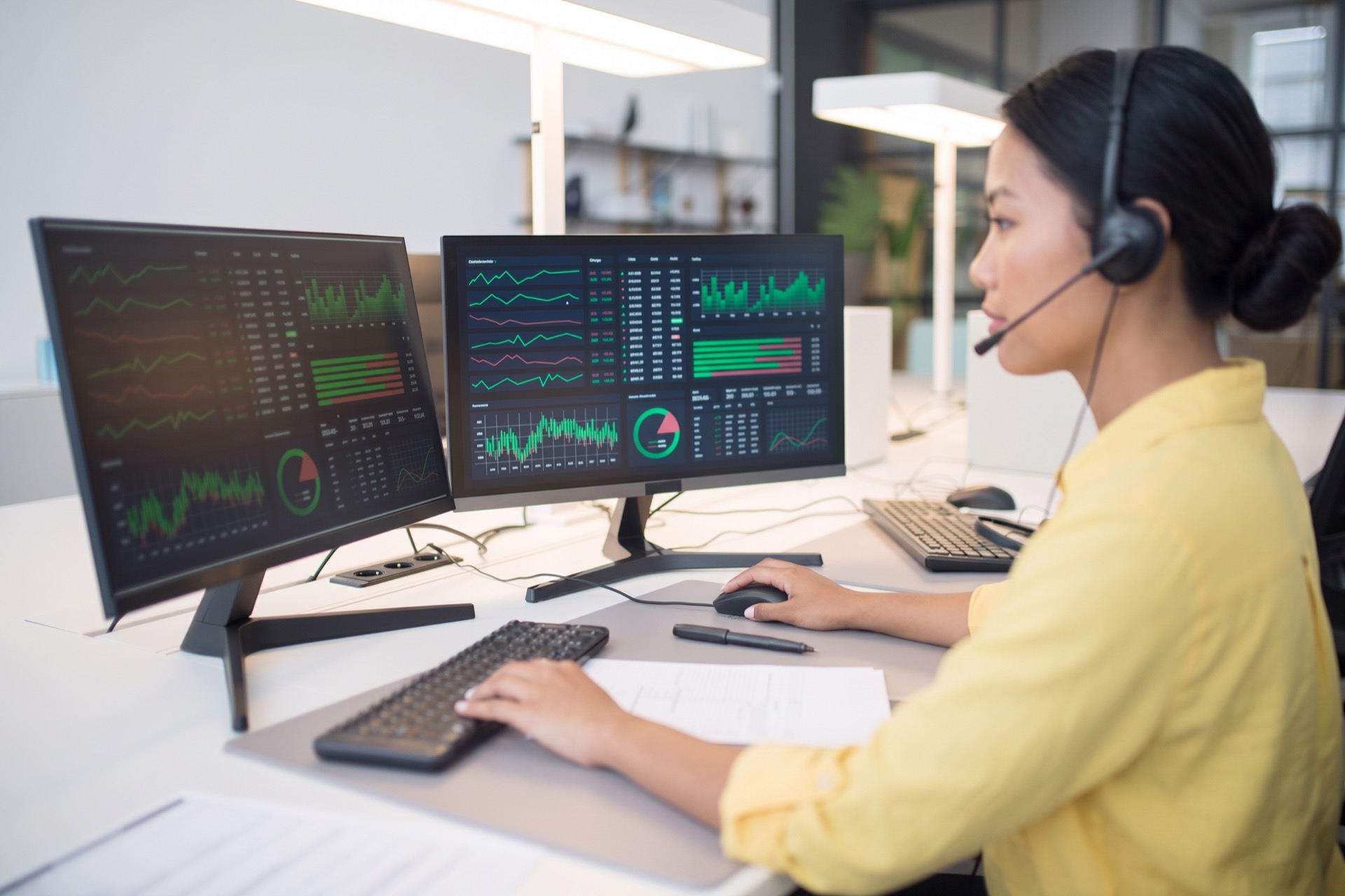 Analyst tracking live data dashboards at an ADTechnologies operations console